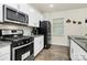 Contemporary kitchen with stainless steel appliances, granite counters, and sleek subway tile backsplash at 16138 Aryshire Green Ct, Charlotte, NC 28273