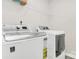 This laundry room features a washing machine, a dryer, and a wire shelf at 16138 Aryshire Green Ct, Charlotte, NC 28273