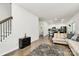 Hardwood floors throughout a spacious living room that leads to a modern kitchen with stainless appliances at 16138 Aryshire Green Ct, Charlotte, NC 28273
