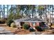 Well-maintained brick home with mature landscaping, charming shutters, and a cozy front porch at 1738 Matheson Ave, Charlotte, NC 28205