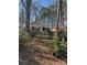 Quaint brick home nestled among mature trees with a charming fence and well-kept lawn at 1738 Matheson Ave, Charlotte, NC 28205