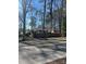 Charming brick home with mature trees, a quaint fence, and well-maintained yard at 1738 Matheson Ave, Charlotte, NC 28205