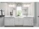 Bright bathroom featuring dual vanities, decorative mirrors, and a window for natural light at 1805 Ab Moore Jr Dr # 3237, Indian Trail, NC 28079