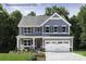 Charming two-story home featuring a two-car garage, well-manicured lawn, and welcoming front porch perfect for relaxing at 1805 Ab Moore Jr Dr # 3237, Indian Trail, NC 28079