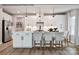Modern kitchen featuring stainless steel appliances, a kitchen island with bar seating and sleek white cabinetry at 1805 Ab Moore Jr Dr # 3237, Indian Trail, NC 28079