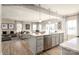 An open-concept kitchen boasts stainless steel appliances, an island with a sink, and seamless flow into the living area at 1805 Ab Moore Jr Dr # 3237, Indian Trail, NC 28079