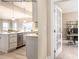 Modern kitchen featuring stainless steel appliances, a kitchen island, and a view into a sunlit office space at 1805 Ab Moore Jr Dr # 3237, Indian Trail, NC 28079