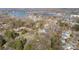 Aerial view showcasing the home's position with lakeside community amidst lush trees at 20016 Walter Henderson Rd, Cornelius, NC 28031