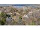 Aerial view showcasing the home's position with lakeside community amidst lush trees at 20016 Walter Henderson Rd, Cornelius, NC 28031