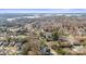 Aerial shot of the home within a community, highlighting lot lines and the surrounding natural landscape at 20016 Walter Henderson Rd, Cornelius, NC 28031