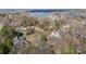 Scenic aerial view of a lakeside community with homes nestled among lush trees at 20016 Walter Henderson Rd, Cornelius, NC 28031
