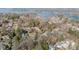 Expansive aerial view of a lakeside community showcasing homes nestled among trees at 20016 Walter Henderson Rd, Cornelius, NC 28031