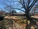 Charming single-story home with mature trees and a lush front yard at 201 Wingrave Dr, Charlotte, NC 28270