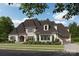 Beautiful two-story home featuring stone accents, an arched entryway, manicured landscaping, and a spacious driveway at 211 Sugar Maple Ln, Weddington, NC 28104