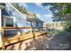 Backyard wooden deck with chairs and a barbecue grill, perfect for outdoor entertaining at 2137 Highland St, Charlotte, NC 28208