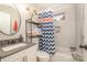 Stylish bathroom with modern vanity, patterned shower curtain, and updated fixtures at 2137 Highland St, Charlotte, NC 28208