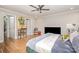 Spacious bedroom with hardwood floors, ceiling fan, and ensuite walk-in closet for ample storage at 2137 Highland St, Charlotte, NC 28208
