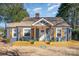 Charming blue house with a covered porch and light wood shutters creates an inviting curb appeal at 2137 Highland St, Charlotte, NC 28208