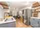 Open kitchen and dining area with stainless steel appliances, gray cabinets, and hardwood floors at 2137 Highland St, Charlotte, NC 28208