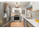 Modern kitchen with stainless steel appliances, gray cabinets, and eat-in breakfast bar at 2137 Highland St, Charlotte, NC 28208