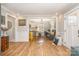 Inviting living room featuring hardwood floors, neutral paint, and seamless flow to the kitchen and dining area at 2137 Highland St, Charlotte, NC 28208