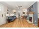 Sun-filled living room featuring a decorative fireplace, modern ceiling fan, and beautiful hardwood floors at 2137 Highland St, Charlotte, NC 28208