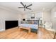 Spacious main bedroom featuring hardwood floors, neutral tones, a ceiling fan and two windows at 2137 Highland St, Charlotte, NC 28208