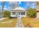 Charming single story home with landscaped yard, stone pathway, and inviting front porch at 216 Blackwelder St, Kannapolis, NC 28081