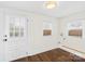 Bright spare room featuring hardwood floors, natural light, and a door with a pet door insert at 216 Blackwelder St, Kannapolis, NC 28081