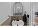Stylish half bathroom with modern sink, wood-look accent wall, and elegant mirror at 2462 Willow Pond Se Ln, Concord, NC 28025