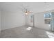 Bright bedroom with neutral carpet, fan, and natural light from two windows at 2462 Willow Pond Se Ln, Concord, NC 28025
