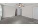 Neutral bedroom with fan, closet, and white painted doors at 2462 Willow Pond Se Ln, Concord, NC 28025