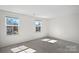 Bright bedroom featuring neutral carpet and natural light from two windows at 2462 Willow Pond Se Ln, Concord, NC 28025