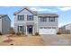 Two-story home with gray siding, black shutters, two car garage, and a well-maintained lawn at 2462 Willow Pond Se Ln, Concord, NC 28025
