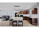 Stylish kitchen with wooden cabinets, granite counters, island with stools, and sleek black appliances at 2462 Willow Pond Se Ln, Concord, NC 28025