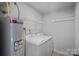 Functional laundry area with washer, dryer, and water heater at 2462 Willow Pond Se Ln, Concord, NC 28025