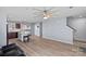Bright living room with hardwood floors, neutral paint, ceiling fan, and convenient access to kitchen at 2462 Willow Pond Se Ln, Concord, NC 28025