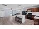 Open-concept living area with island seating, wood floors, ceiling fan, and plenty of natural light at 2462 Willow Pond Se Ln, Concord, NC 28025