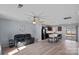 Comfortable living room with wood floors, neutral paint, ceiling fan, and a modern leather sofa at 2462 Willow Pond Se Ln, Concord, NC 28025