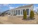 Inviting screened porch extends to a stone patio with built-in seating, offering outdoor relaxation at 4018 Moxie Way, Charlotte, NC 28215