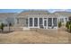 Landscaped backyard features a patio with outdoor seating and an enclosed sunroom at 4018 Moxie Way, Charlotte, NC 28215