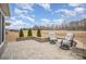 Outdoor patio with brick pavers and swivel chairs overlooks serene backyard at 4018 Moxie Way, Charlotte, NC 28215