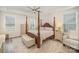 Spacious primary bedroom featuring a four-poster bed and natural light at 4018 Moxie Way, Charlotte, NC 28215