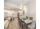 Elegant dining room with a modern chandelier adjacent to an open-concept kitchen at 4018 Moxie Way, Charlotte, NC 28215