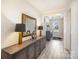 Inviting foyer featuring hardwood floors, decorative mirror, and stylish console table at 4018 Moxie Way, Charlotte, NC 28215