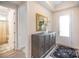 Bright entryway featuring hardwood floors, stylish console table, and access to bathroom at 4018 Moxie Way, Charlotte, NC 28215