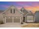 Charming brick and siding home featuring a well-manicured lawn and an attached two-car garage at 4018 Moxie Way, Charlotte, NC 28215