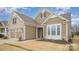 Well-maintained home featuring brick and siding accents, attached garage, and manicured front lawn at 4018 Moxie Way, Charlotte, NC 28215