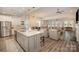 Modern kitchen with a large island, stainless steel appliances, and views of the living room at 4018 Moxie Way, Charlotte, NC 28215