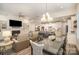 Open concept living space with fireplace, built-in shelving, and adjacent dining area at 4018 Moxie Way, Charlotte, NC 28215
